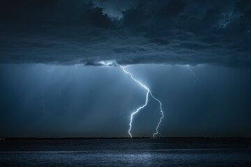 Wall Mural - thunderclouds near the dutch coast from which lightning strikes the mainland