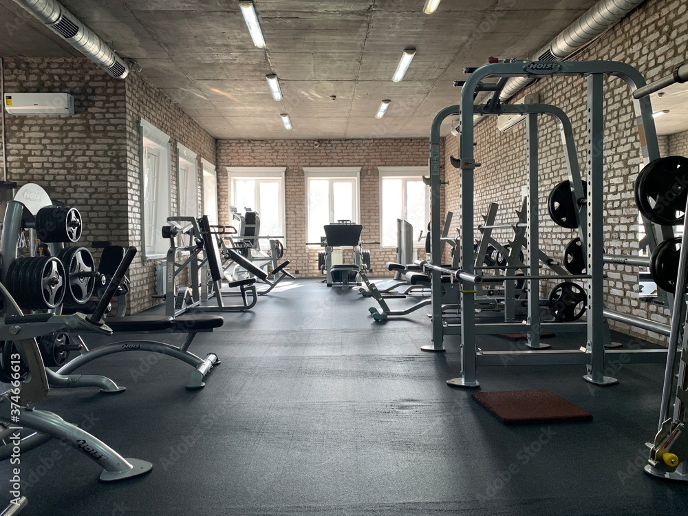 Gym for bodybuilding. Heavy dumbbells and exercise equipment. Barbells ...