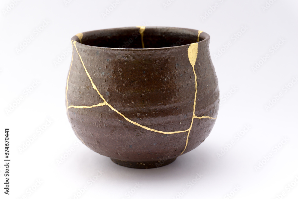 Kintsugi brown tea ceremony chawan bowl. Gold cracks restoration on old ...