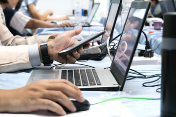 asian teacher groups computer training technology or coding application in smartphone with laptop fo