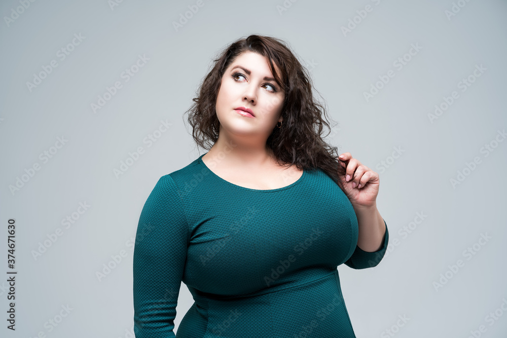 Plus size fashion model in green dress, fat woman on gray background, body positive concept Stock Photo | Adobe Stock Plus size fashion model in green dress, fat woman on gray background, body positive concept Stock Photo | Adobe Stock