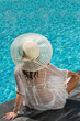© Netfalls - woman in luxury spa resort near the swimming pool.