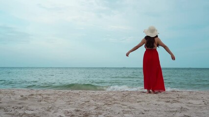 Wall Mural - freedom woman walking with arms raised on the sea beach with wind blow

