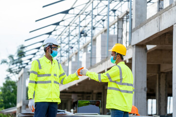 Aufkleber - Construction engineer greeting with elbow while wearing protective face masks at construction site.