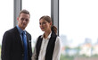 © Arunporn - Business partners concept. Young businessman and businesswoman smiling in modern office.
