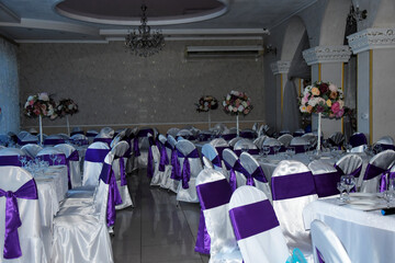 Banquet hall with served tables.