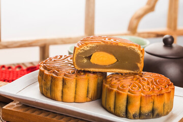 Poster - Mid-Autumn Festival concept, Traditional mooncakes on table  with teacup