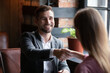 © fizkes - Smiling man executive greeting successful candidate on job interview in cafe, acquaintance, shaking hands, sitting at table, positive happy client making deal with realtor, financial advisor