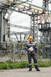 © Andrii - The energy engineer inspects the equipment of the substation. Power engineering. Industry