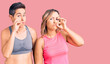© Krakenimages.com - Couple of women wearing sportswear mouth and lips shut as zip with fingers. secret and silent, taboo talking