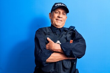 Senior man with grey hair wearing police uniform happy face smiling with crossed arms looking at the camera. positive person.