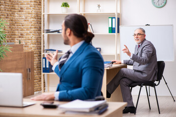 Two male colleagues working in the office