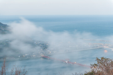 Sticker - A fantastic image of fog down the river was shot in Japan