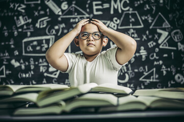 Wall Mural - Boys with glasses write books and think in the classroom