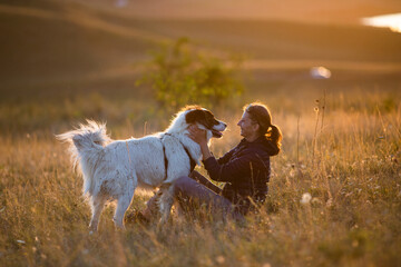 Sticker - happy woman with white dog in autumn landscape