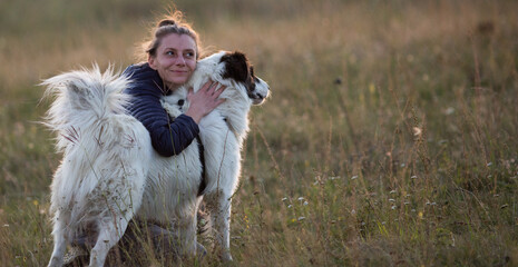 Sticker - happy woman with white dog in autumn landscape