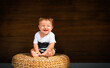 © Vasleriia Kuznetsova - baby sitting at the straw chair