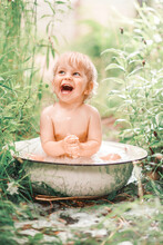 Cute Funny Little Boy Bathing In Galvanized Tub Outdoor In Green Garden