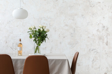 Sticker - Dining table with wine and bouquet of flowers near light wall