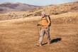© Mediteraneo - Senior man on hike through beautiful countryside in autumn.