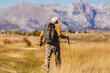 © Mediteraneo - Senior man on hike through beautiful countryside in autumn.