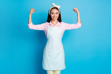 Wall Mural - Portrait of sporty cleaning service worker woman show her triceps hands muscles ready wash home house wear good look clothes isolated over blue color background