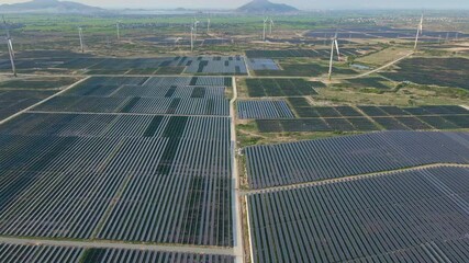 Aerial shot of a huge solar power plant in a big field. Electricity generation from solar energy. Green energy and zero emissions concept
