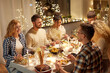 © Syda Productions - holidays, celebration and people concept - happy smiling friends having christmas dinner party at home in evening