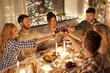 © Syda Productions - holidays, celebration and people concept - happy friends having christmas dinner at home drinking non-alcoholic red wine