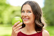 © Syda Productions - healthy eating, dental and people concept - portrait of happy woman with green apple at summer park