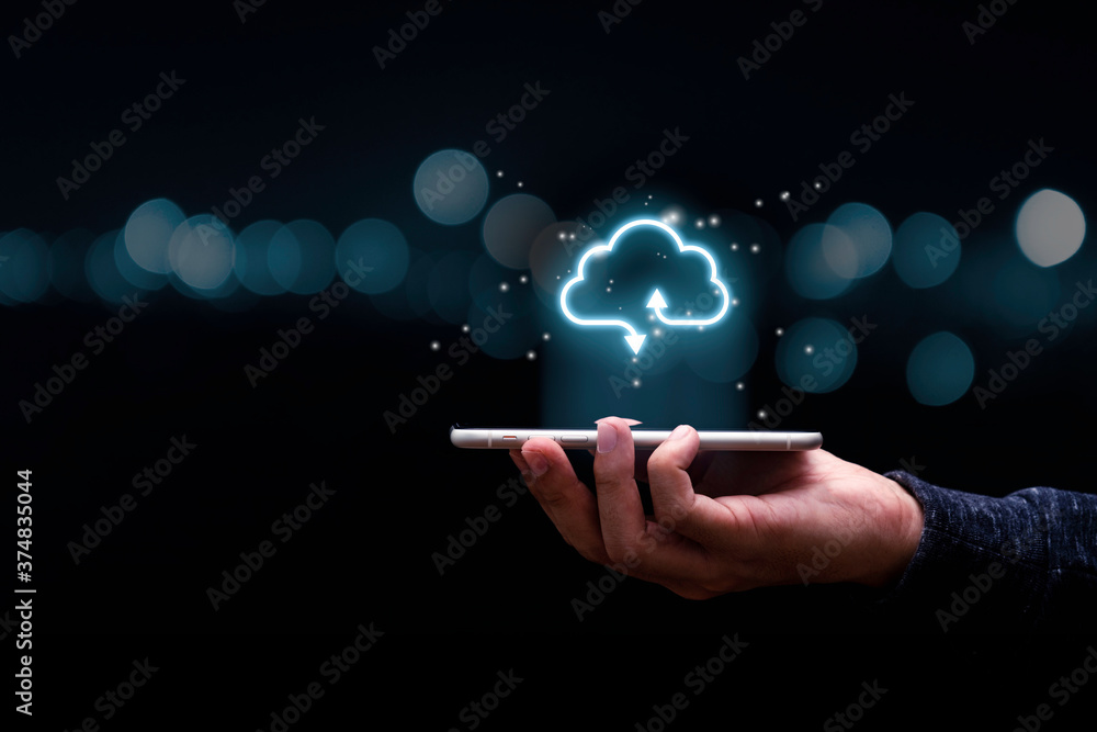 Businessman holding mobile phone with virtual cloud computing to transfer data information and upload download application. Technology transformation concept. - obrazy, fototapety, plakaty 