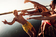 © Zoran Zeremski - Group of young friends having fun enjoying a summer day swimming and jumping at the lake.