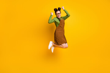 Poster - Full size photo of ecstatic high school girl jump raise fists scream yes wear green pullover skirt overall isolated over bright shine color background