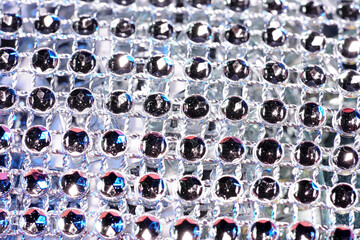 Sticker - Closeup shot of silver beads on a colorful background