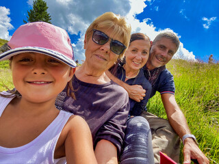 Canvas Print - Three generations female with a man on a mountain excursion