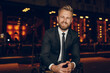 © kegfire - Cheerful well dressed businessman in night city