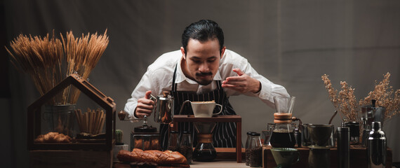 Hand drip coffee filter, barista pouring hot water on roasted coffee ground with filter