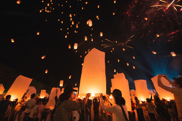 Loy krathong festival, thai new year party with floating lanterns release in the night sky