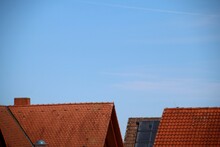 Low Angle View Of Roofs Against Blue Sky