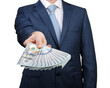 © Alekss - Businessman in a suit holding money cash in hands of passing them to the client.