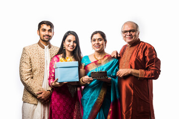 Wall Mural - Senior Indian asian woman celebrating birthday with husband, son, daughter in law and grand daughter