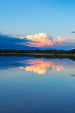 Fototapeta Morze - Beautiful sunset by the lake. Bright clouds are reflected in the water. Kyrgyzstan.