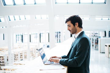 Smart manager using laptop in library