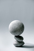 Abstract Background With Composition Of Balanced Grey Geometric Objects Sphere And Stones. Copy Space. Modern Concept For Product Presentation.