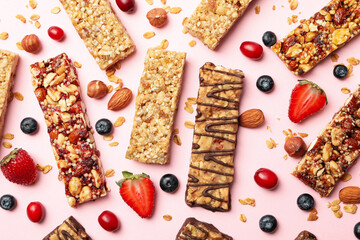 Wall Mural - Tasty granola bars on pink background, top view