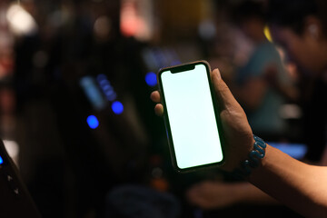 close up hand showing green screen smart phone while exercising on treadmill in gym room at night. b