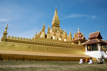 Pilgrims Praying At The Great Stupa In Vientiane, Laos.