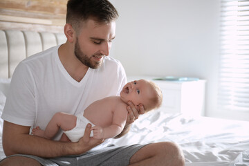 Canvas Print - Father with his newborn son at home