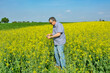 © banedeki1 - Agronomist inspecting quality of canola field