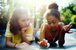 © Halfpoint - Front view of young teenager girls friends outdoors in garden, talking.
